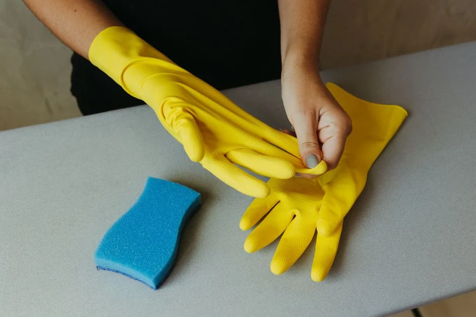 why-choose-us A worker cleaning the windows of a skyscraper while secured in a harness, highlighting high-rise urban work.